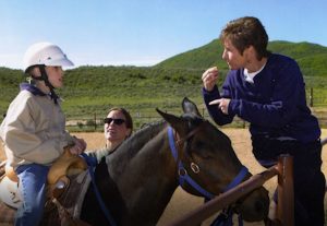 Meeche working with a participant at the NAC Equestrian Center